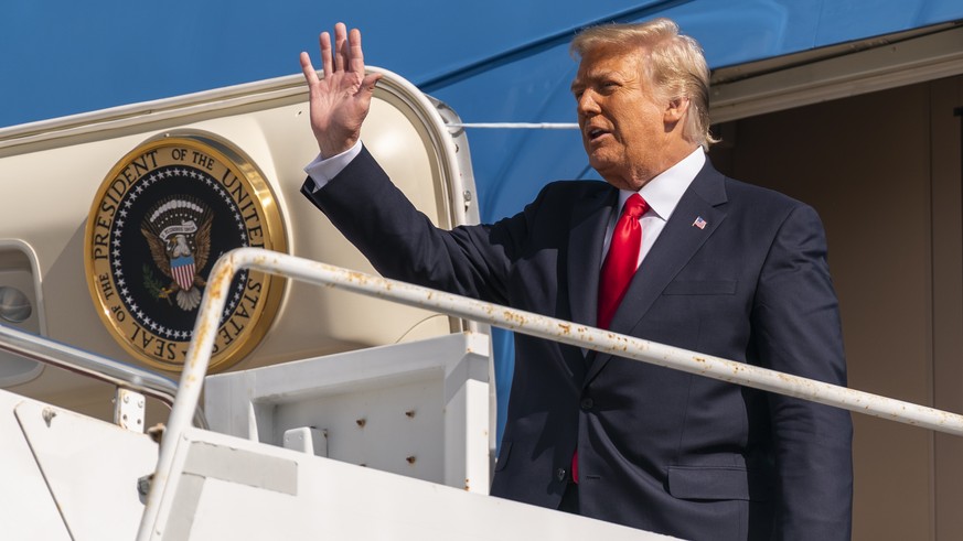 Former President Donald Trump waves as he disembarks from his final flight on Air Force One at Palm Beach International Airport in West Palm Beach, Fla., Wednesday, Jan. 20, 2021. (AP Photo/Manuel Bal ...