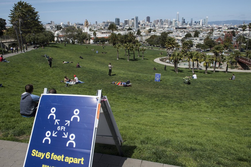 Delores Park, usually packed with sunbathers on a beassutiful day, has only a few people, in San Francisco on Sunday, April 19, 2020. San Francisco Mayor London Breed says that efective now, face mask ...