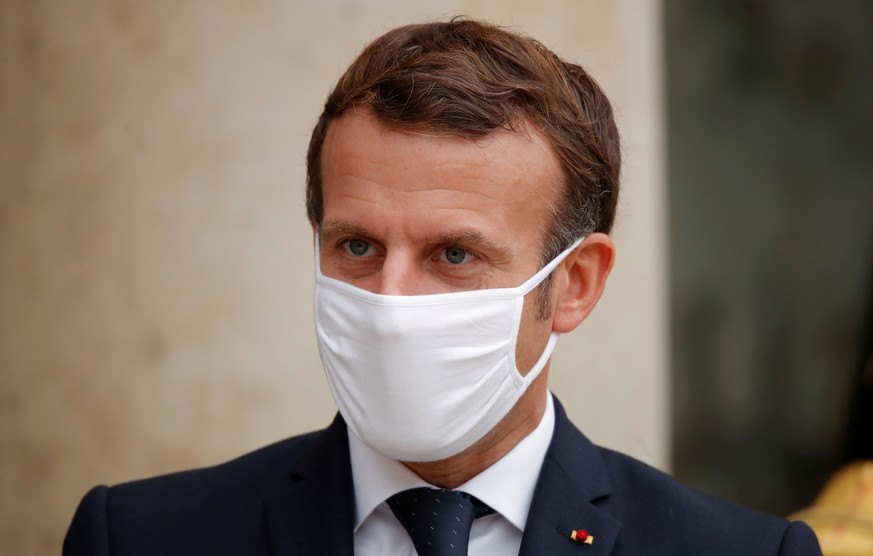 French President Emmanuel Macron, wearing a protective face mask, stands outside the Elysee Palace in Paris, France, October 28, 2020. REUTERS/Charles Platiau