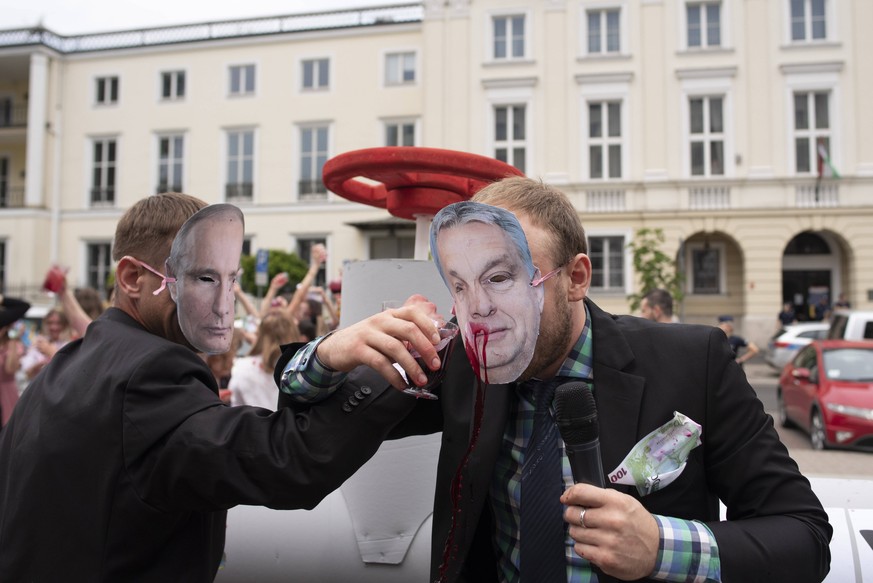 June 4, 2022, Warsaw, Warsaw, Poland: Activists impersonating Russias President Vladimir Putin and Hungary s PM Viktor Orban stand next to a mock-up of a gas pipeline and drink a blood-like liquid whi ...