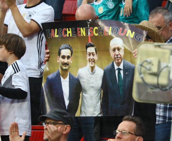 Fans halten das Foto hoch, mit dem alles begann: Erdogan mit Özil und Gündogan.