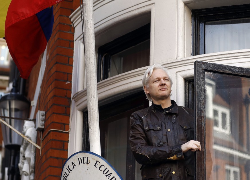 FILE- In this May 19, 2017 file photo, WikiLeaks founder Julian Assange greets supporters from a balcony of the Ecuadorian Embassy in London. Ecuador’s foreign minister said Monday, June 4, 2018, ther ...