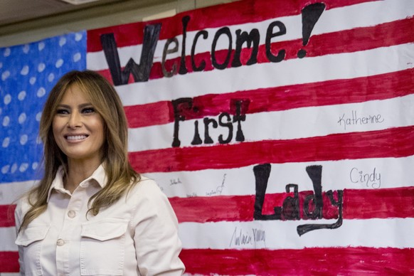 First lady Melania Trump smiles after signing American flag artwork while visiting the Upbring New Hope Children Center run by the Lutheran Social Services of the South in McAllen, Texas, Thursday, Ju ...
