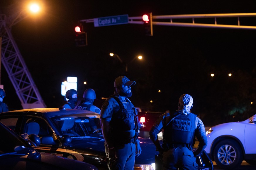 ATLANTA, GA - JUNE 14: Police watch the streets after a day of marches on June 14, 2020 in Atlanta, Georgia. A memorial is found at the ste of the Wendy's restaurant which was set ablaze overnight. Ra ...