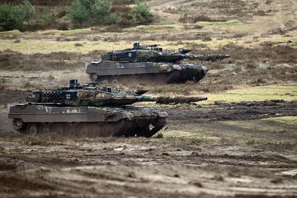 ARCHIVE - February 1st, 2023, North Rhine-Westphalia, Augustdorf: Two Leopard 2A6 of the Bundeswehr's 203rd tank battalion drive over the Senne military training area.  The Ukrainian armed forces have from Germany ...