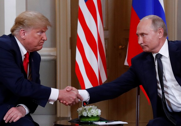 U.S. President Donald Trump and Russia's President Vladimir Putin shake hands as they meet in Helsinki, Finland July 16, 2018. REUTERS/Kevin Lamarque