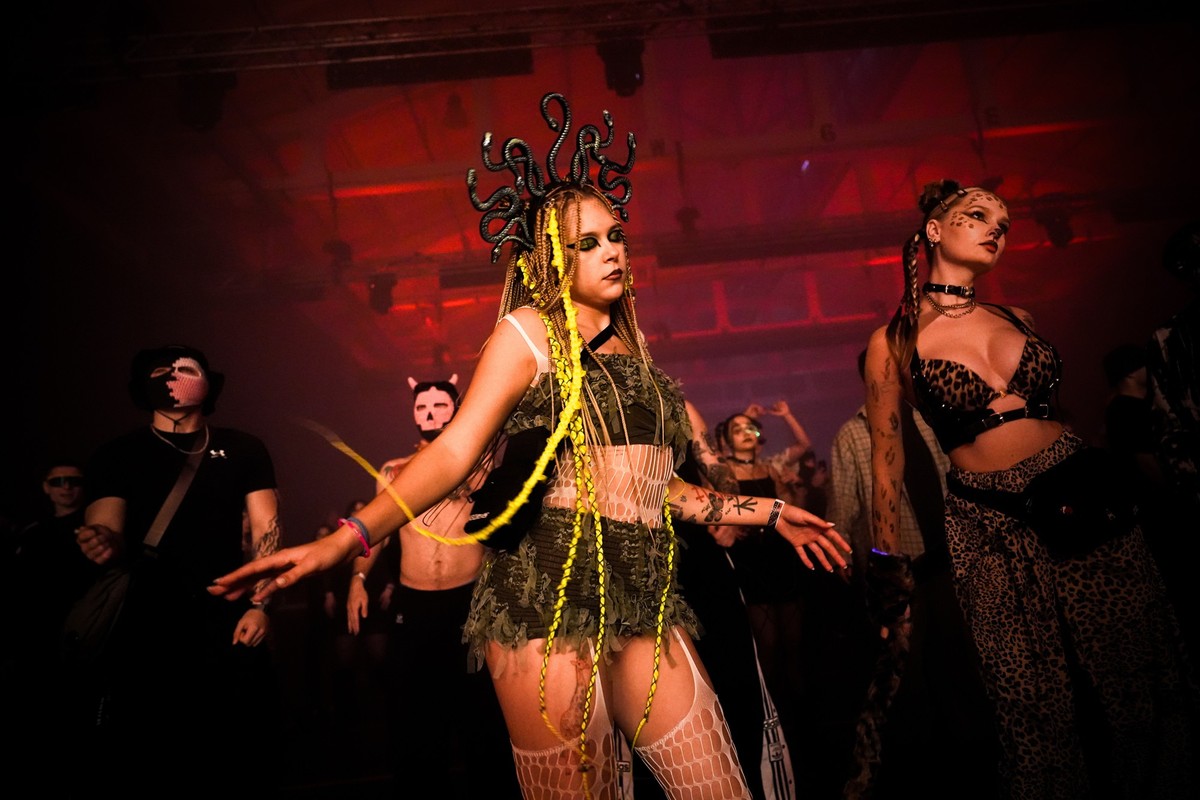 A woman wearing a Medusa hairpiece dances during a Halloween rave in Kyiv, Ukraine, Saturday, Oct. 25, 2025. (AP Photo/Julia Demaree Nikhinson)
