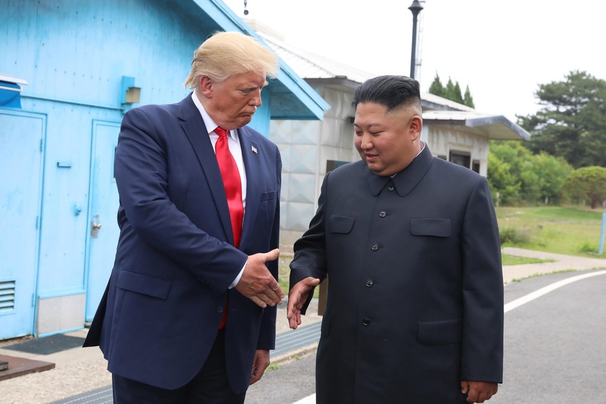 PANMUNJOM, SOUTH KOREA - JUNE 30 (SOUTH KOREA OUT): A handout photo provided by Dong-A Ilbo of North Korean leader Kim Jong Un and U.S. President Donald Trump inside the demilitarized zone (DMZ) separ ...