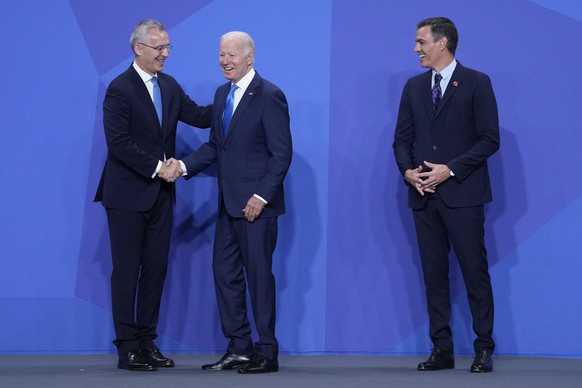 U.S. President Joe Biden, center, is welcomed by NATO Secretary General Jens Stoltenberg, left, next to Spanish Prime Minister Pedro Sanchez at the official arrivals for the NATO summit in Madrid, Spa ...