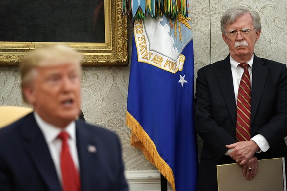WASHINGTON, DC - JULY 18: White House National Security Advisor John Bolton (R) listens to U.S. President Donald Trump as he and Dutch Prime Minister Mark Rutte talk to reporters in the Oval Office at ...
