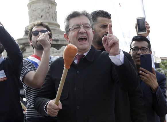 French far-left leader Jean-Luc Melenchon greets supporters and shouts slogans during a protest against French President Emmanuel Macron's government reforms, in Marseille, France, Saturday, Apri ...