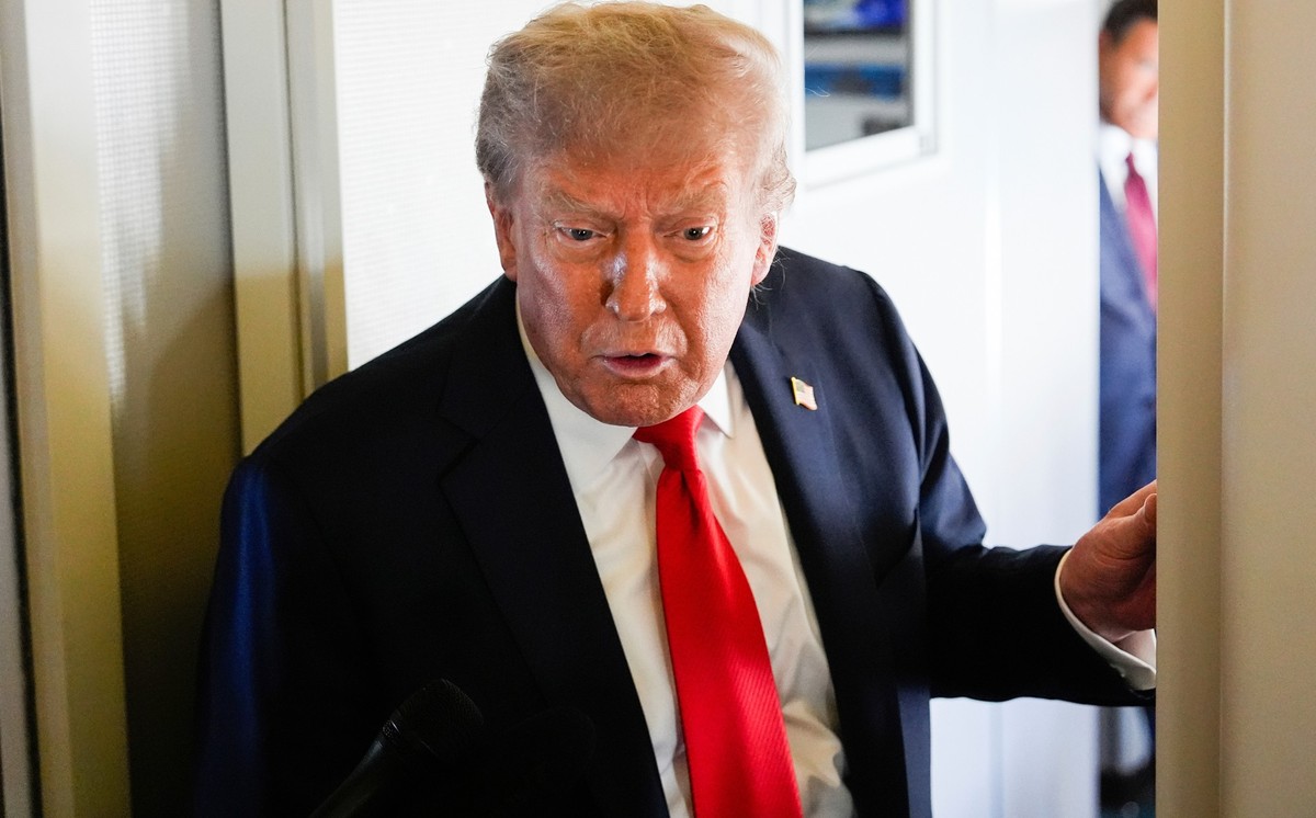President Donald Trump speaks to reporters aboard Air Force One while en route to meet with Russia's President Vladimir Putin at Joint Base Elmendorf-Richardson, Alaska, Friday, Aug. 15, 2025. (A ...