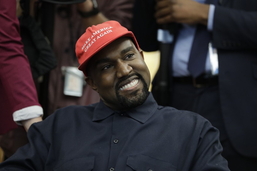 FILE - Rapper Kanye West wears a Make America Great again hat during a meeting with President Donald Trump in the Oval Office of the White House in Washington on Oct. 11, 2018. West says he is no long ...