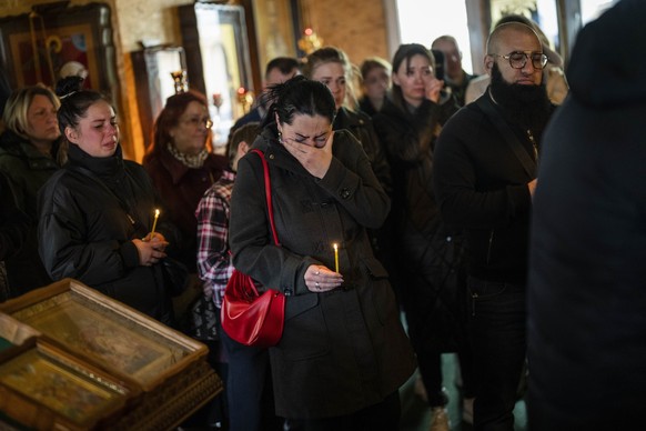 ++ CORRECTS AGES ++ A woman cries during the funeral of Sofia Shulha, 11, and Pysarev Kiriusha, 17, in Uman, central Ukraine, Sunday, April 30, 2023. Shulha and Kiriusha were killed during a Russian a ...