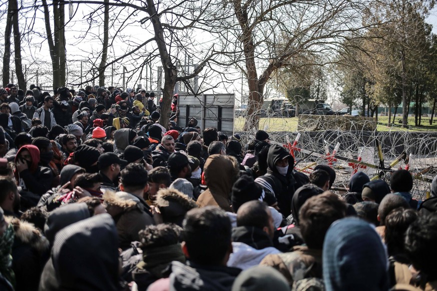 March 1, 2020, Edirne, Edirne, Turkey: A picture taken on March 1, 2020. Refugees sit in a field near the Pazarkule gate in Edirne region, at the Turkish-Greek border. Migrants and refugees hoping to ...