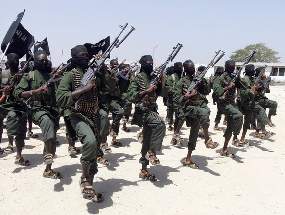 FILE - In this Thursday, Feb. 17, 2011 file photo, hundreds of newly trained al-Shabab fighters perform military exercises in the Lafofe area some 18 km south of Mogadishu, in Somalia. The Somalia-bas ...
