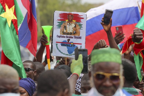 Supporters of Burkina Faso&#039;s latest coup leader Capt. Ibrahim Traore gather outside the National Assembly waving Burkina and Russian flags as Traore was appointed Burkina Faso&#039;s transitional ...