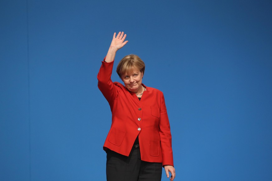 ESSEN, GERMANY - DECEMBER 06: German Chancellor and Chairwoman of the German Christian Democrats (CDU) Angela Merkel waves to applauding delegates after she gave her central speech at the 29th federal ...