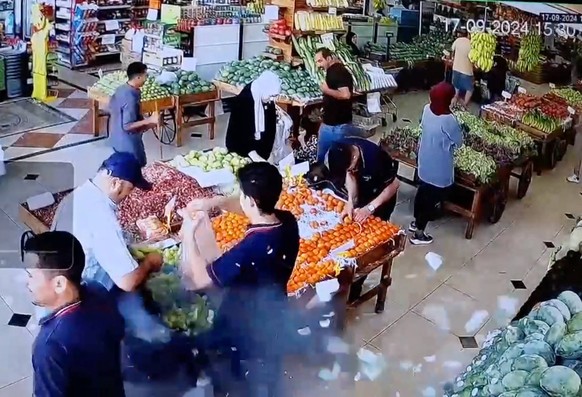 Exploding Pagers Kill Nine And Injure Thousands - Lebanon A CCTV footage screenshot shows the moment of the explosion of the pager of a vegetables shop client 2nd from L, at 3:30,on September 17, 2024 ...