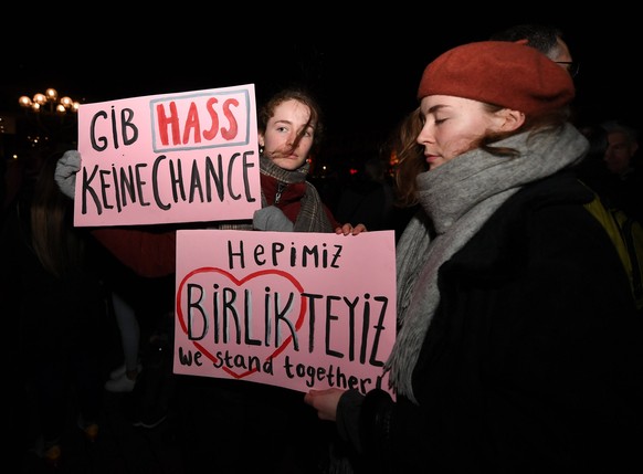 200220 -- HANAU GERMANY, Feb. 20, 2020 -- People hold Placards read Do not give hate any chance in German and We stand together in Turkish and English at a gathering event to mourn for the victims in  ...