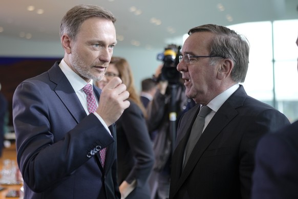 German Finance Minister Christian Lindner, left, talks with Defense Minister Boris Pistorius, right, during the weekly cabinet meeting of the German government at the chancellery in Berlin, Germany, W ...