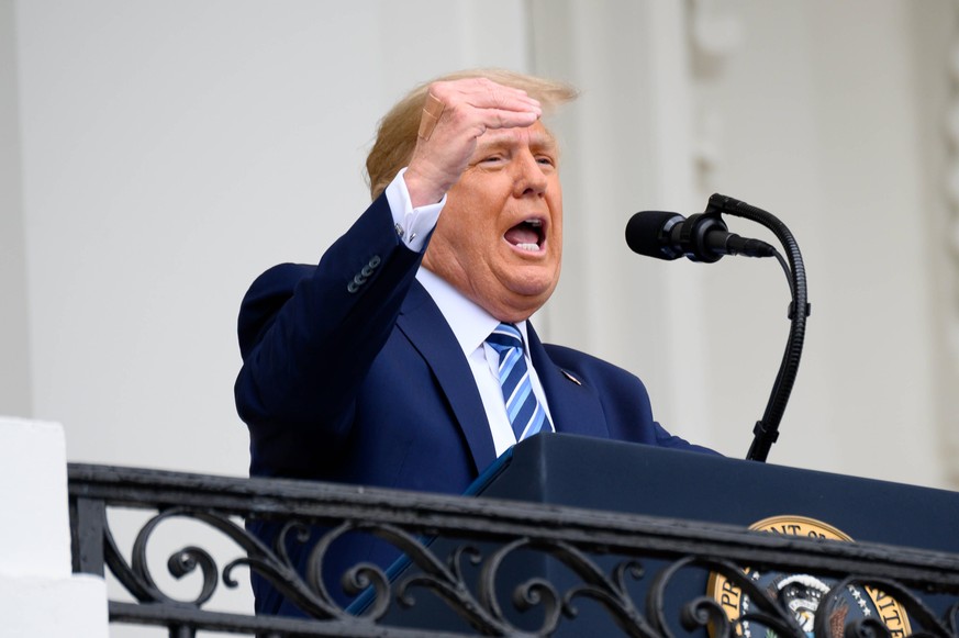 A bandage is seen on U.S. President Donald Trump s hand while speaking from the Truman Balcony of the White House in Washington, D.C., U.S., on Saturday, Oct. 10, 2020. Trump, making his first public  ...