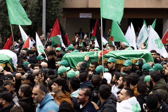 January 4, 2024, Beirut, Lebanon: Men carry caskets during the funeral for Saleh al-Arouri, deputy chief of Hamas s political bureau, and two others as their funeral procession makes its way from the  ...