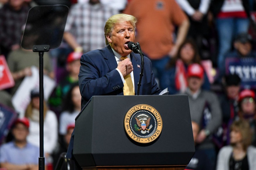 COLORADO SPRINGS, CO - FEBRUARY 20: President Donald Trump mocks choking while describing Democratic Presidential candidate Mike Bloomberg's debate performance during a Keep America Great rally on Feb ...
