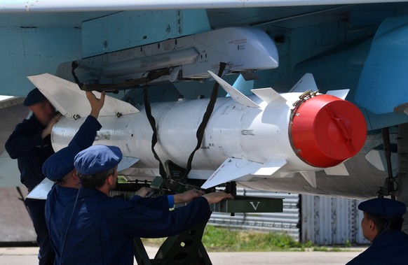 Ukraine Russia Military Operation 8220356 19.06.2022 Technicians attach an air-to-surface X-29 aircraft missile on the armament suspension unit of the Russia s Su-34 fighter-bomber before a combat mis ...