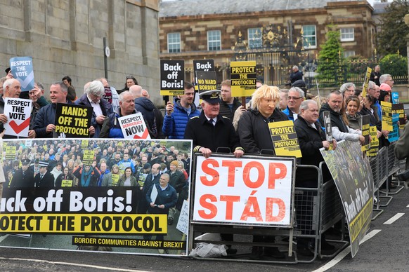 16.05.2022, Gro�britannien, Hillsborough: Demonstranten protestieren vor dem Hillsborough Castle vor einem Besuch des britischen Premierministers Johnson. Johnson erneuerte die britischen Drohungen, d ...