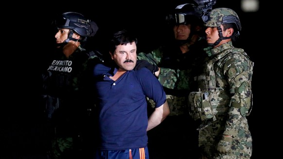 FILE PHOTO: Soldiers escort drug lord Joaquin &quot;El Chapo&quot; Guzman during a presentation to the media in Mexico City, Mexico January 8, 2016. REUTERS/Tomas Bravo/File Photo