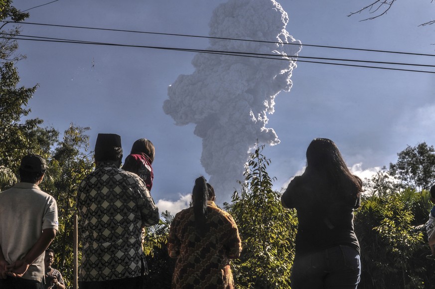 Residents watch as Mount Merapi erupts in Cangkringan, Yogyakarta, Indonesia, Friday, June 1, 2018. The country&#039;s most volatile volcano shot a towering plume of ash about 6 kilometers (4 miles) h ...