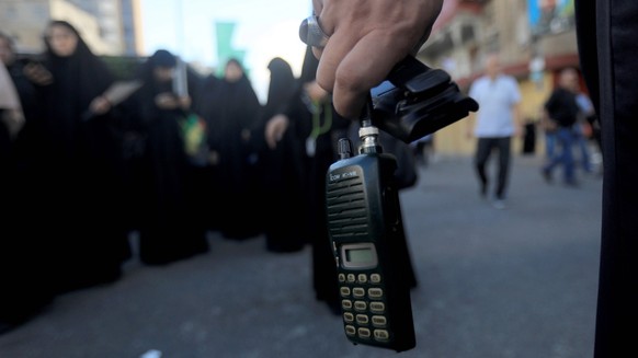 240918 -- BEIRUT, Sept. 18, 2024 -- Photo taken on Sept. 18, 2024 shows a wireless communication device in the hand of a Hezbollah member, the battery of which was removed after a wireless communicati ...