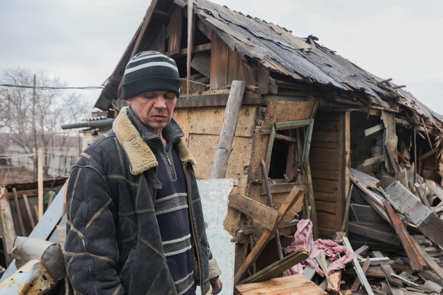 DONETSK PEOPLE&#039;S REPUBLIC - FEBRUARY 24, 2022: A man is seen next to the ruins of a house destroyed by shellfire in Gorlovka. The People&#039;s Militia has reported one civilian dead and another  ...