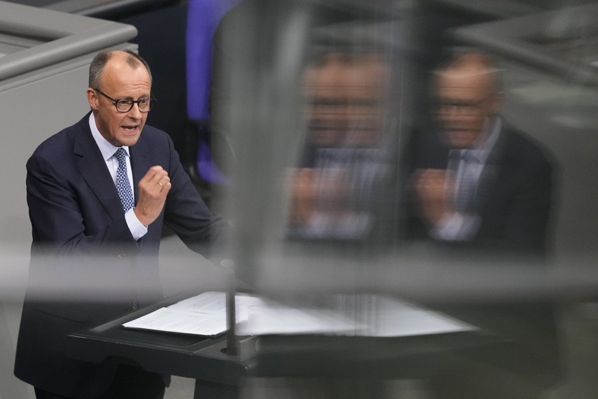 German opposition leader and Christian Union parties floor leader Friedrich Merz speaks at the the beginning of a debate about migration at the German parliament Bundestag in Berlin, Germany, Wednesda ...