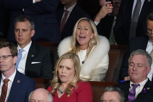 Rep. Majorie Taylor Greene, R-Ga., center, listens and reacts as President Joe Biden delivers his State of the Union speech to a joint session of Congress, at the Capitol in Washington, Tuesday, Feb.  ...