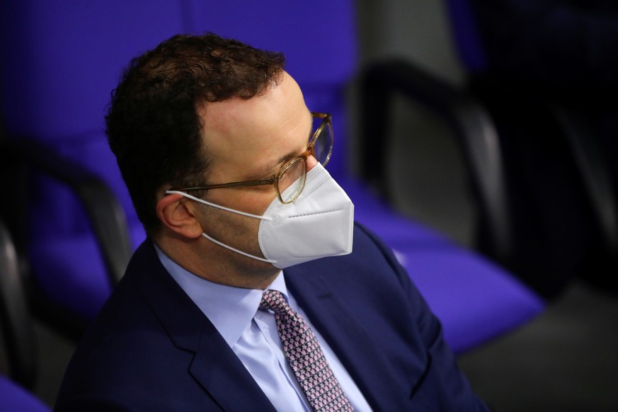 German Health Minister Jens Spahn wears a protective mask as German Chancellor Angela Merkel (not pictured) delivers a speech on the government&#039;s response to the coronavirus disease (COVID-19) pa ...