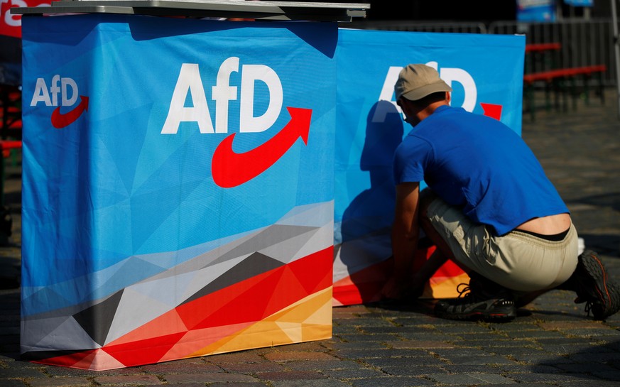 A man helps to set up banners at an election campaign of Germany&#039;s far-right Alternative For Germany (AFD) party ahead the upcoming Saxony state elections in Dresden, Germany, August 25, 2019. RE ...