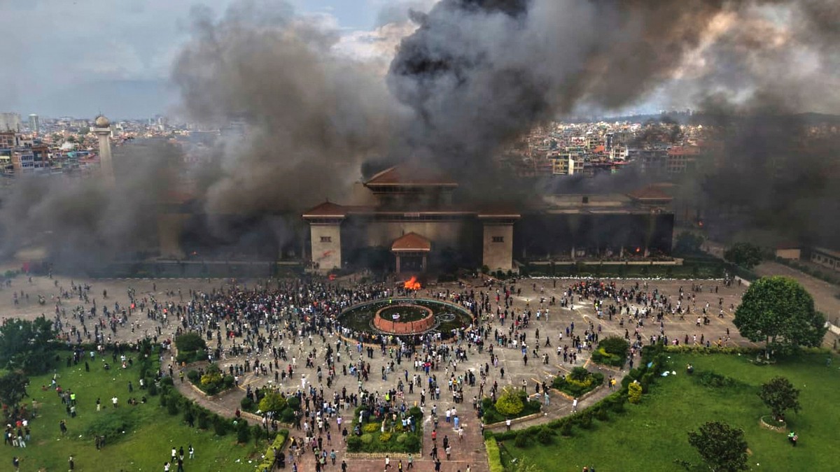 Protesters celebrate at the Singha Durbar, the seat of Nepal&#039;s government&#039;s various ministries and offices after it was set on fire during a protest against social media ban and corruption i ...