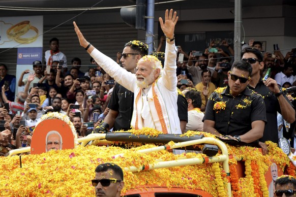 Indian Prime Minister Narendra Modi waves to the crowd during a road show to campaign for his Bharatiya Janata Party (BJP) ahead of the elections in Bengaluru, India, Sunday, May 7, 2023. The election ...