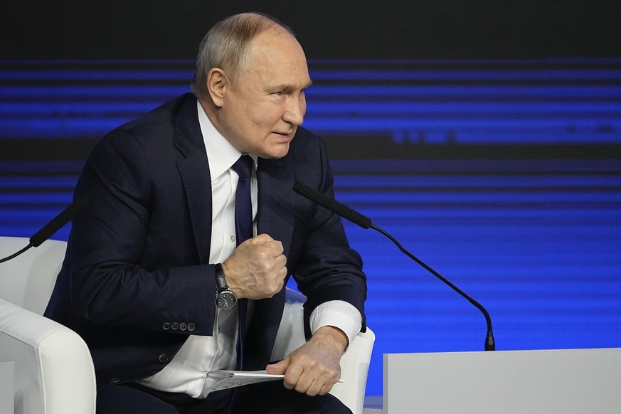 Russian President Vladimir Putin gestures while speaking during a meeting with his election campaign activists in Moscow, Russia, Wednesday, Jan. 31, 2024. Presidential elections are scheduled in Russ ...