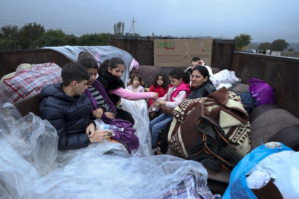 25.09.2023, Armenien, Kornidzor: Ethnische Armenier aus Berg-Karabach sitzen in einem Lastwagen auf dem Weg nach Kornidzor in der Region Syunik. Nach der Eroberung des Gebiets Berg-Karabach im Südkauk ...