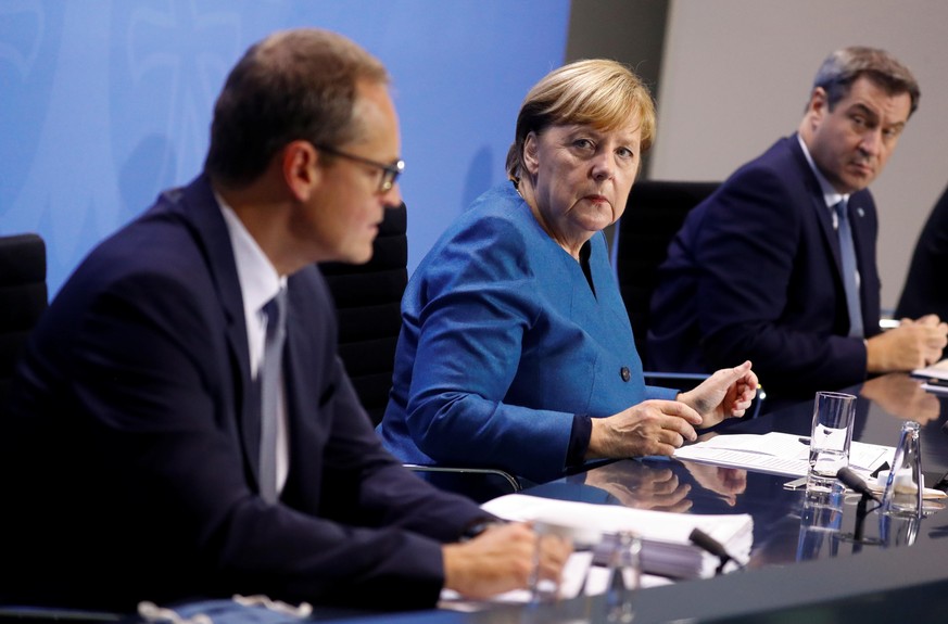 German Chancellor Angela Merkel, Bavarian Prime Minister Markus Soeder and Berlin&#039;s mayor Michael Mueller attend a news conference at the Chancellery in Berlin, Germany October 28, 2020. REUTERS/ ...
