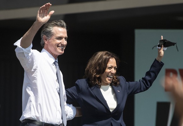 California Governor Gavin Newsom waves with Vice President Kamala Harris at a vote no on recall rally at the IBEW-NECA Joint Apprenticeship Training Center in San Leandro, California on Wednesday, Sep ...