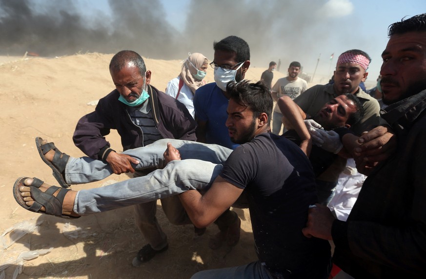 A wounded Palestinian demonstrator is evacuated during a protest marking the 70th anniversary of Nakba, at the Israel-Gaza border in the southern Gaza Strip May 15, 2018. REUTERS/Ibraheem Abu Mustafa