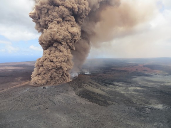 This Friday, May 4, 2018, aerial image released by the U.S. Geological Survey, at 12:46 p.m. HST, a column of robust, reddish-brown ash plume occurred after a magnitude 6.9 South Flank of Kīlauea eart ...