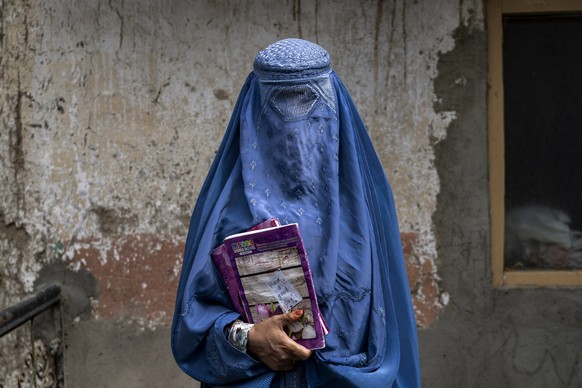 Arefeh 40-year-old, an Afghan woman leaves an underground school, in Kabul, Afghanistan, Saturday, July 30, 2022. She attends this underground school with her daughter who is not allowed to go to publ ...