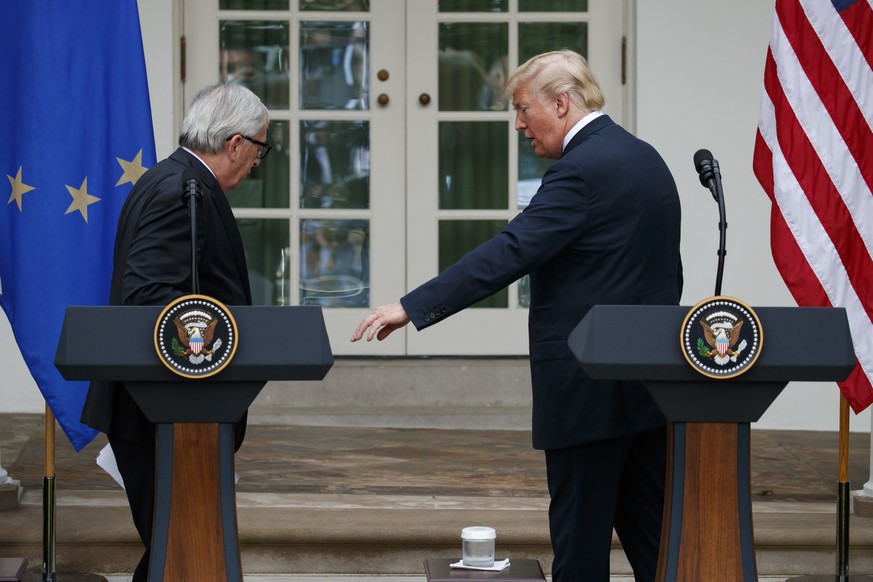 President Donald Trump and European Commission president Jean-Claude Juncker leave the podiums after speaking about trade in the Rose Garden of the White House, Wednesday, July 25, 2018, in Washington ...