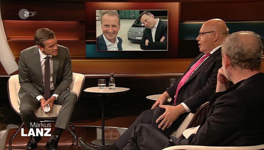 Gastgeber Markus Lanz (l.) mit Wirtschaftsminister Peter Altmaier (Mitte). Auf dem Bildschirm ist Tesla-CEO Elon Musk (r.) mit VW-Chef Herbert Diess zu sehen. 
