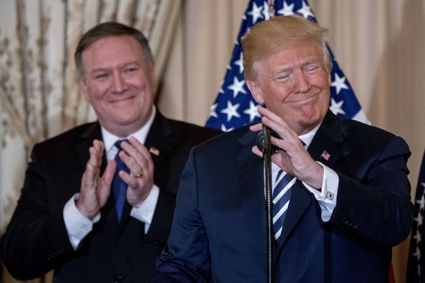 President Donald Trump, accompanied by Secretary of State Mike Pompeo, speaks during a ceremonial swearing in for Pompeo at the State Department, Wednesday, May 2, 2018, in Washington. (AP Photo/Andre ...